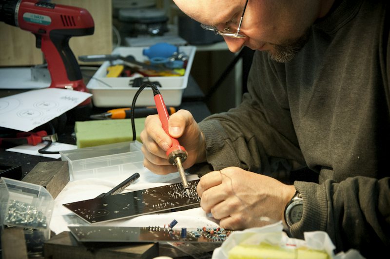 Technician soldering a circuit board