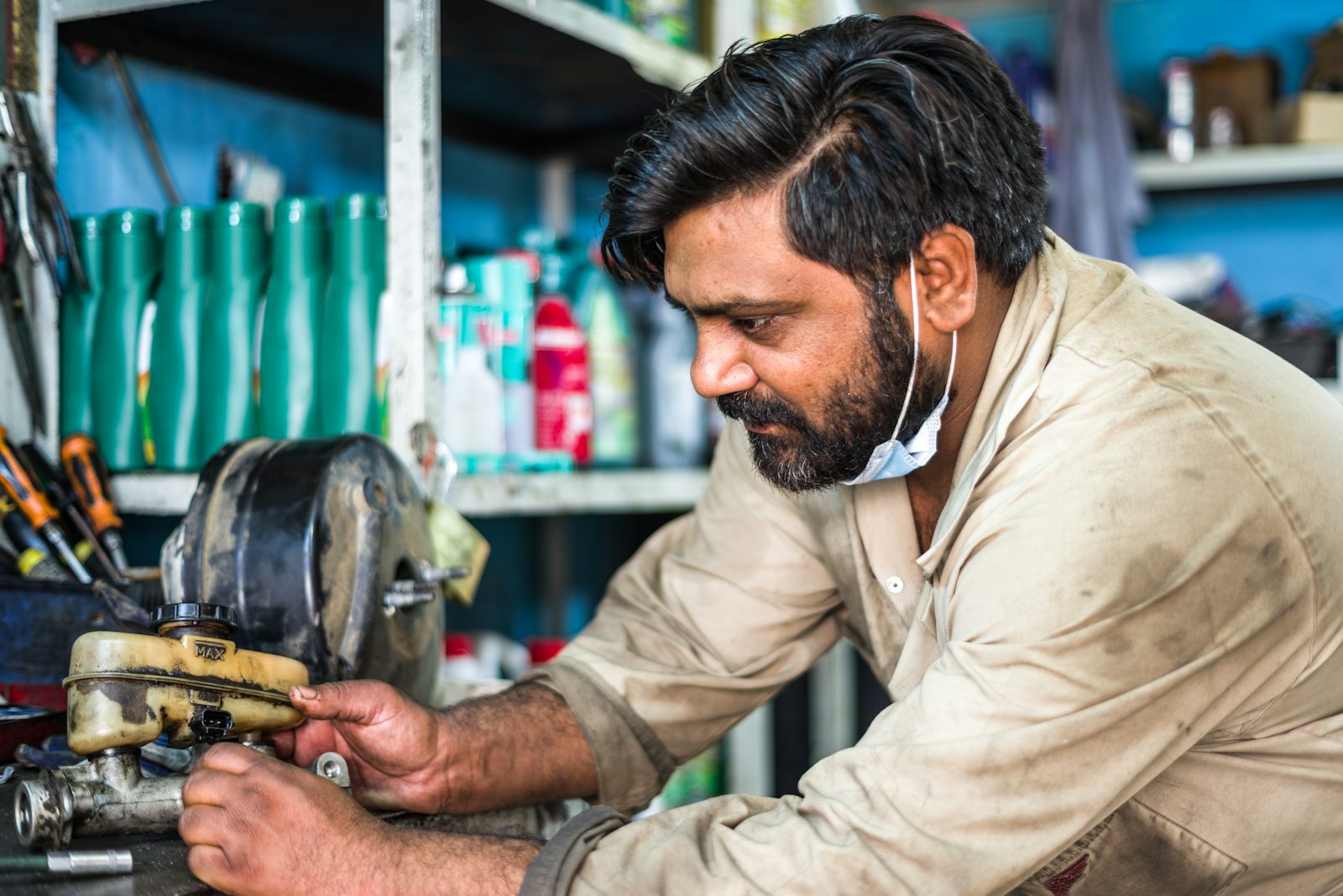 Technician repairing a power tool at a workbench